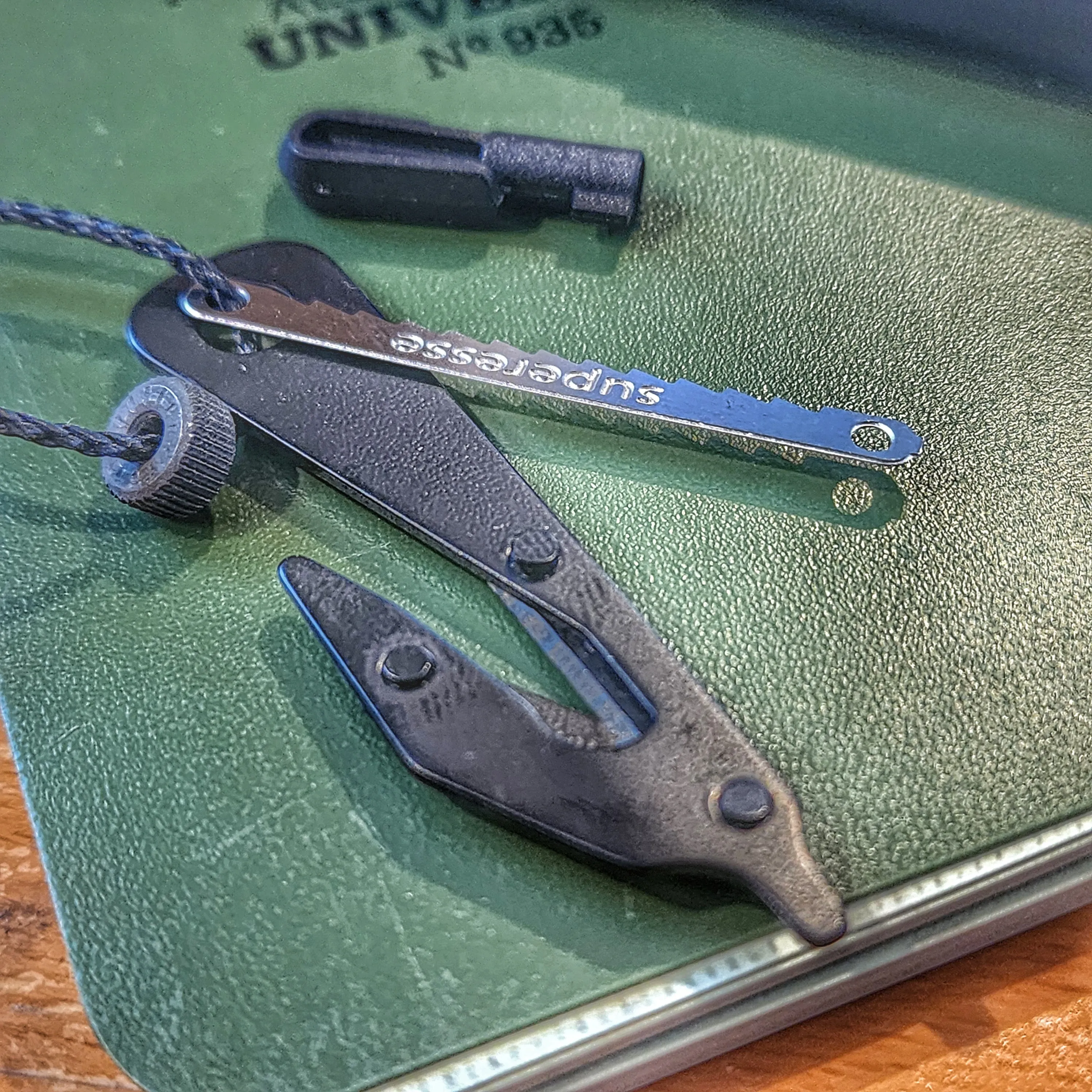 SERE Lanyard: Escape Implements and EDC Tools secured around a kevlar friction saw necklace.